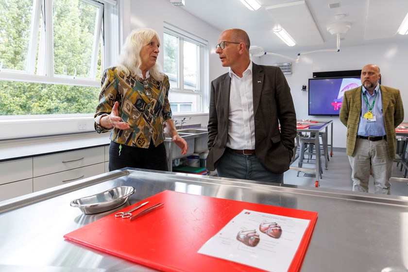 Two people talking in a classroom.