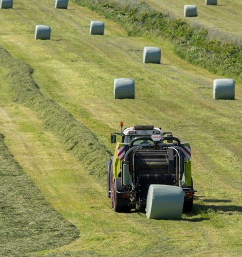 tractor and a silage bale in a field