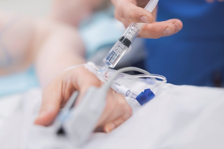 A nurse injects a patient with needed medication