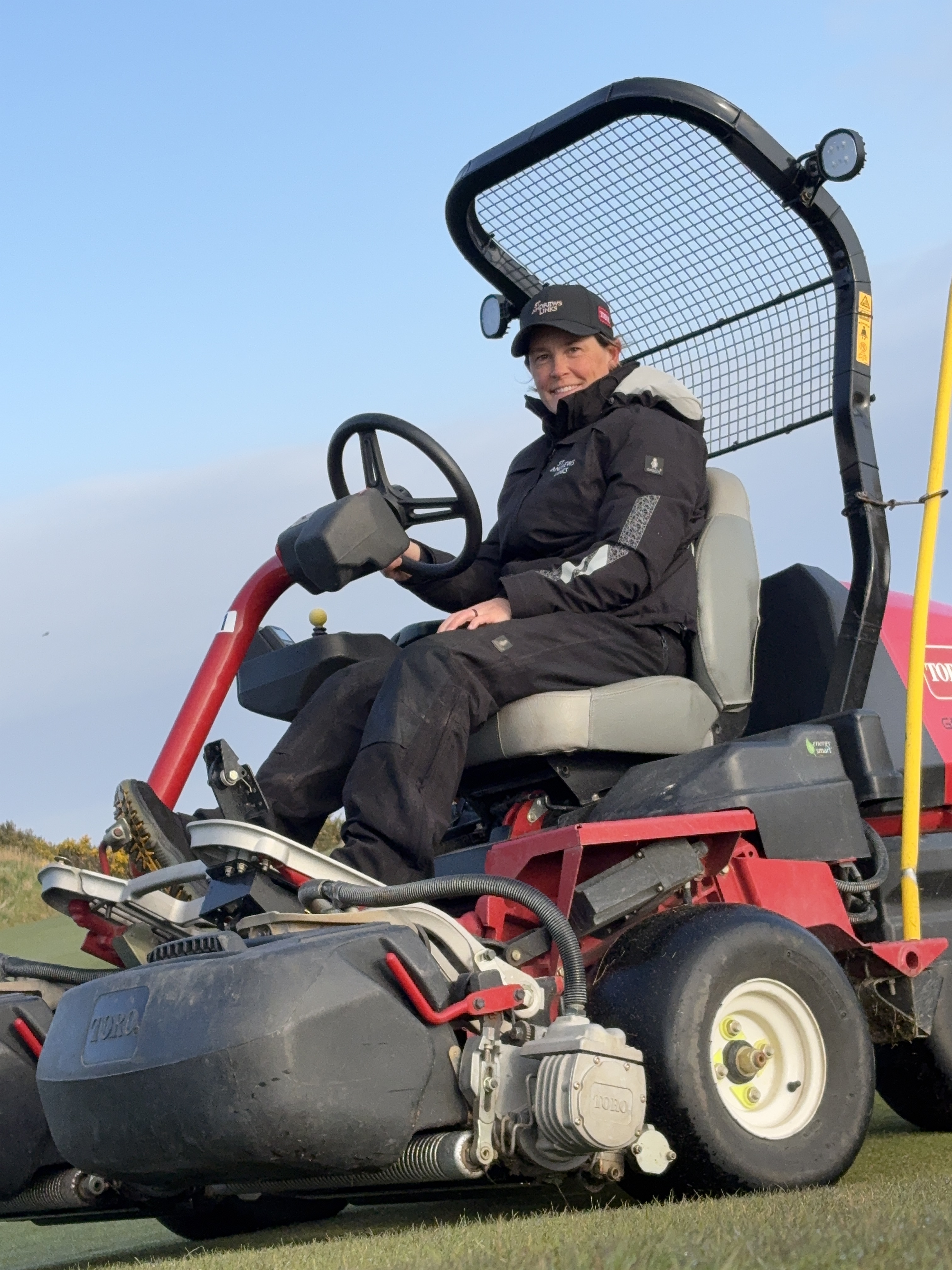 Woman driving a ride-on lawnmower