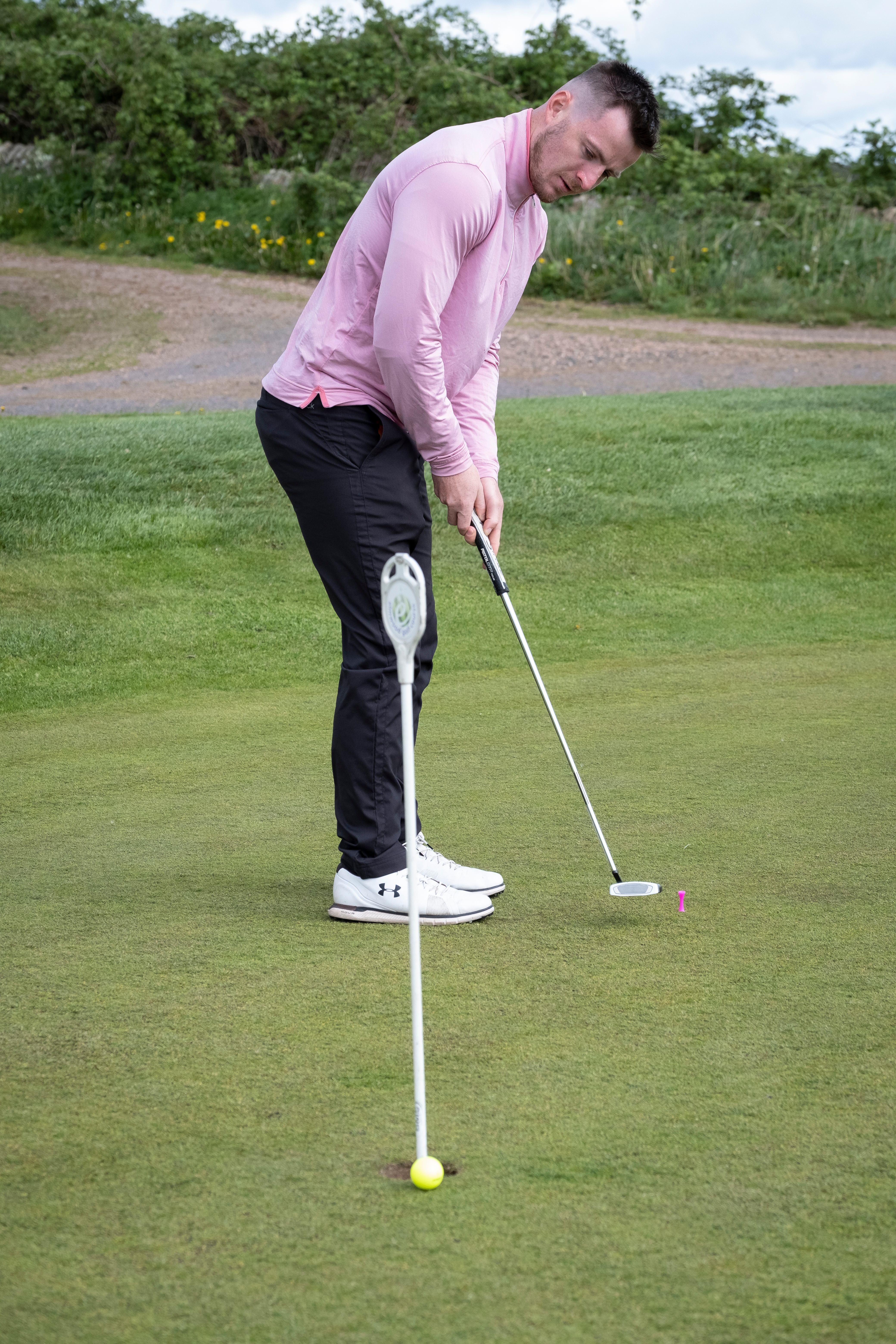 Man playing golf on a putting green
