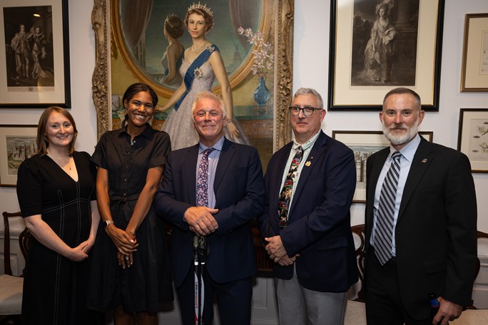 Five people standing in a row at an event as aprt of a USA Exchange visit