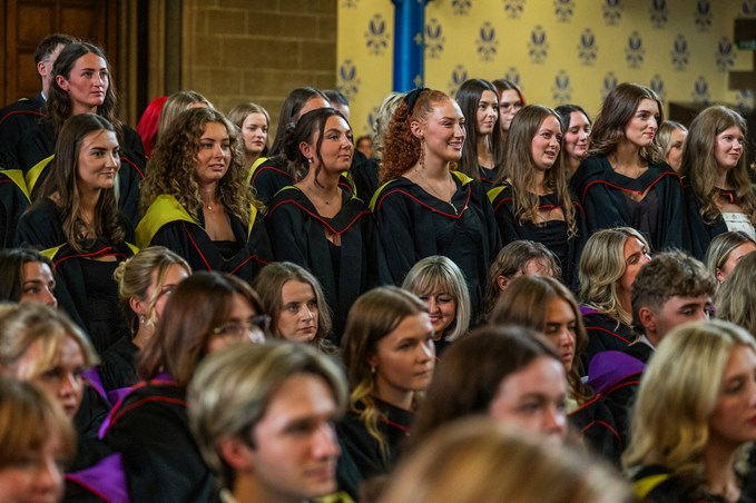 A group of graduates standing in a hall