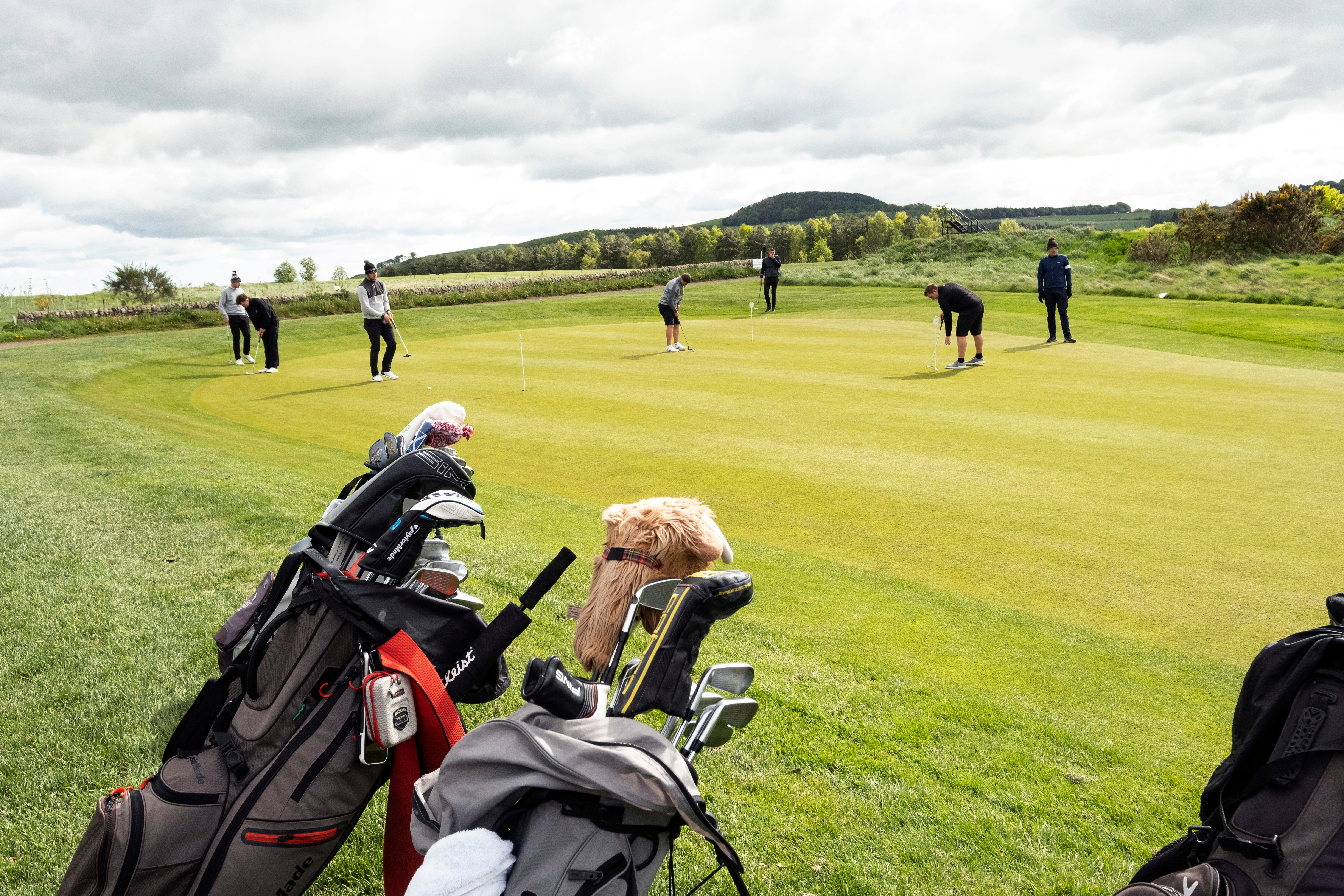 People playing golf on a putting green